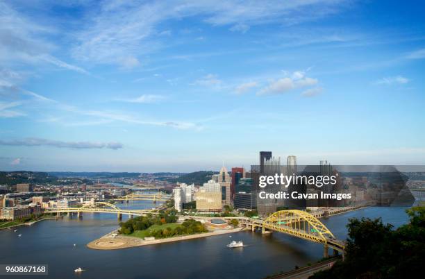 high angle view of bridges over river in pittsburgh city against blue sky - allegheny river stock pictures, royalty-free photos & images
