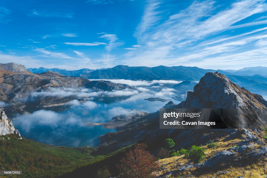 Scenic view of lake and mountains against sky