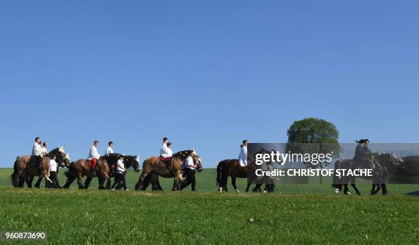 Participants of the traditional Pentecostal parade ride on horses near the Bavarian village of Bad Koetzting, southern Germany, on May 21, 2018. -...
