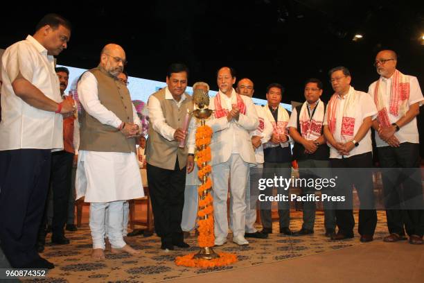 Chief Minister of Assam Sarbananda Sonowal lighting the inauguration lamp of the third conclave of the North East Democratic Alliance at Guwahati,...