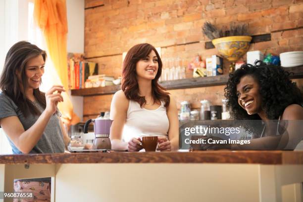 low angle view of female friends enjoying at kitchen - cup day three stock pictures, royalty-free photos & images