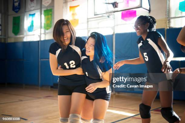 teenage girls enjoying at volleyball court - girls volleyball stock pictures, royalty-free photos & images