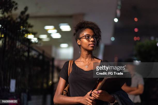 student university walking in the street at night - education building stock pictures, royalty-free photos & images