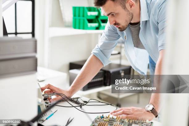 engineer working with circuit boards at table in electronic laboratory - oscilloscope stock pictures, royalty-free photos & images