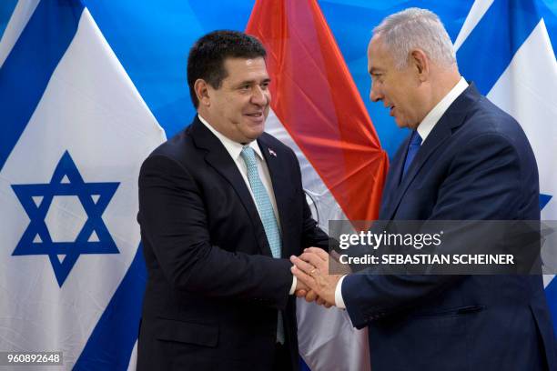 Israeli Prime Minister Benjamin Netanyahu shakes hands with Paraguayan President Horacio Cartes during their meeting at the Prime Minister's office...