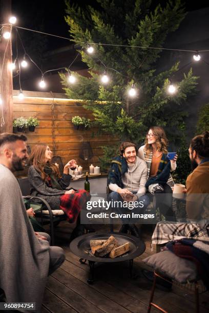 friends enjoying party in backyard at night - garden night photos et images de collection