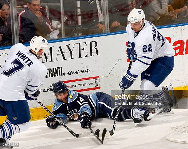 Radek Dvorak of the Florida Panthers battles for the puck along the boards against Ian White of the Toronto Maple Leafs and teammate Francois...
