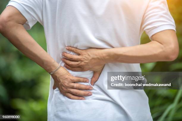sport injury, man with back pain - pain stock pictures, royalty-free photos & images