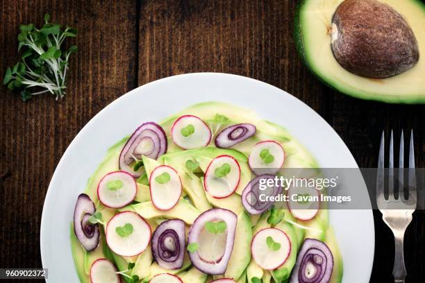 overhead view of avocado salad served in plate on table - dikon radish stock pictures, royalty-free photos & images