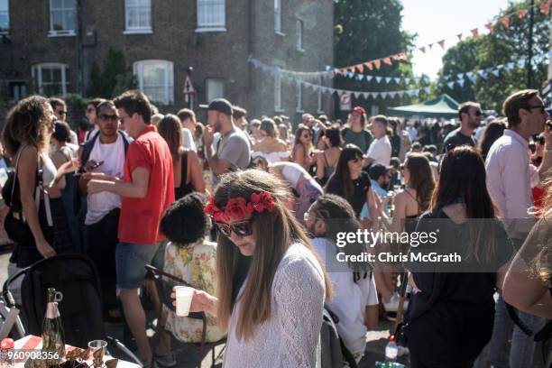 People attend a royal wedding street party to celebrate the marriage of Prince Harry and Meghan Markle at the Wilton Way Hackney street party on May...