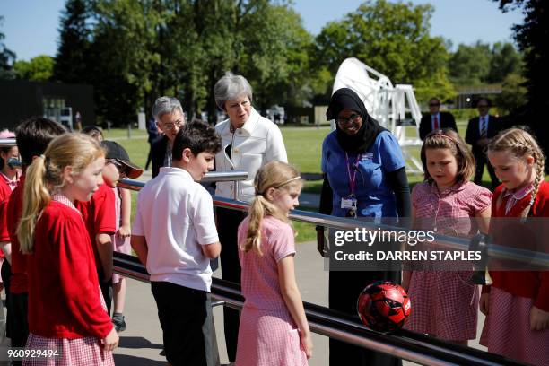 Britain's Prime Minister Theresa May visits a school before visiting the Jodrell Bank Observatory in Macclesfield, north-west England on May 21 where...