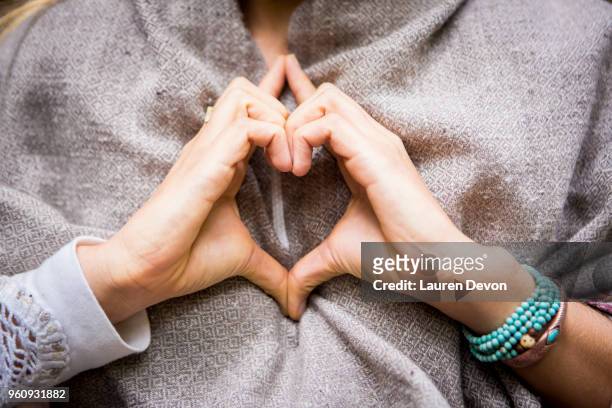 young womans hands making heart shape, cropped - heart bracelet stock pictures, royalty-free photos & images