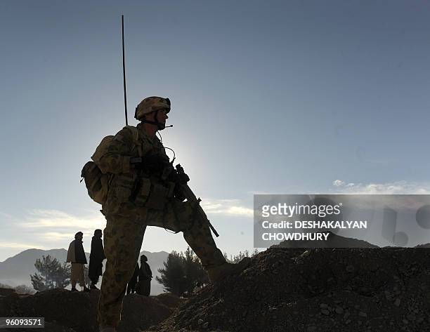An Australian soldier of Omlet-c company keeps vigil outside the district administration office called the 'White Compound' in Mirwais in the...