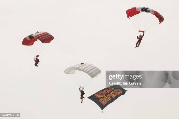 May 21: Members of the Red Devils fly the Royal Enfield flag after jumping from a Douglas Dakota aircraft at IWM Duxford on May 21, 2018 in Duxford,...