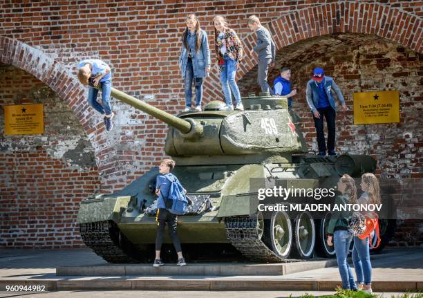 Children play atop a Soviet T-34 tank at a local military museum in Nizhny Novgorod on May 21, 2018.