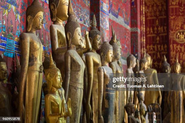 buddha statues at the wat xieng thong temple in luang prabang - laotian culture stock pictures, royalty-free photos & images