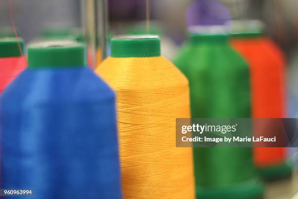 embroidery spools with thread - multiple threads needle stock pictures, royalty-free photos & images