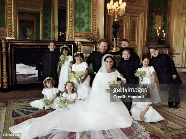 In this handout image released by the Duke and Duchess of Sussex, the Duke and Duchess of Sussex pose for an official wedding photograph with : Back...