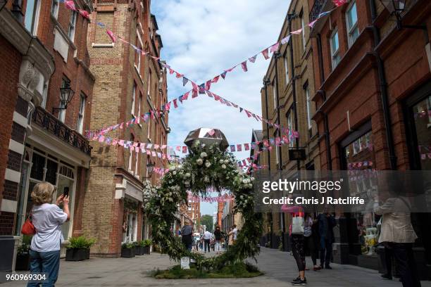 Women take photos of a floral display shaped like a diamond ring during the Chelsea in Bloom floral art show on May 21, 2018 in London, England. This...