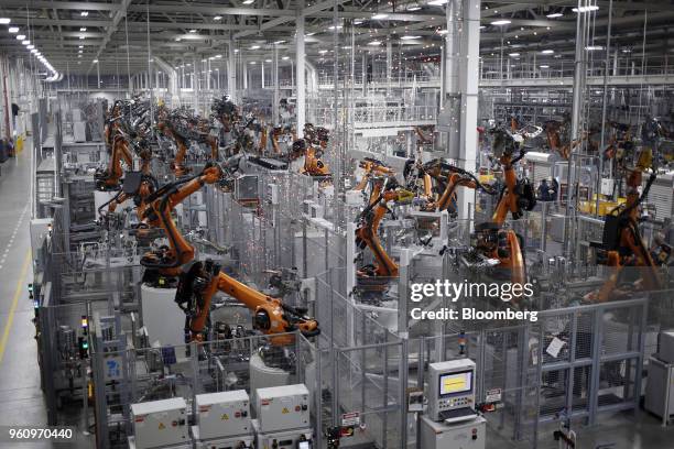 Robots weld car body components for vehicles at the Bayerische Motoren Werke AG Manufacturing Co. Assembly plant in Greer, South Carolina, U.S. On...
