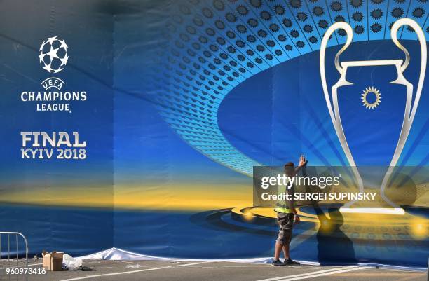Worker sets decoration in the fan zone of the 2018 UEFA Champions League Final in Kiev on May 21 ahead of the football match between Real Madrid and...