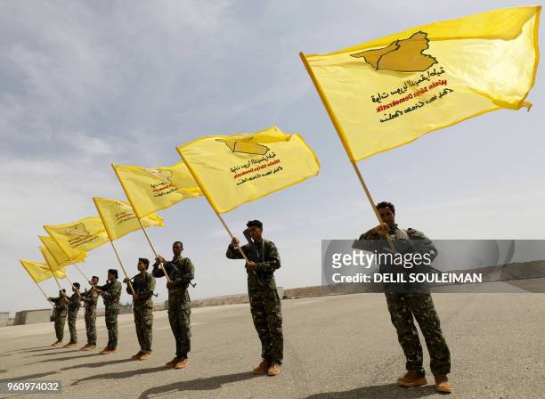 Members of the Syrian Democratic Forces , trained by the US-led coalition, participate in the graduation ceremony of their first regiment in...