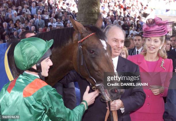 Irish jockey Johnny Murtagh holds Sinndar next to owner Aga Khan and his wife, begum Inaara after winning the Group One Prix de l'Arc de Triomphe at...