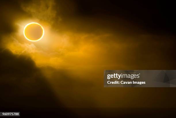 low angle view of solar eclipse in sky during foggy weather - 日食 ストックフォトと画像