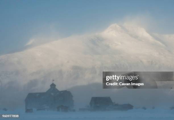 houses against snowcapped mountains during foggy weather - houses of alaska stock pictures, royalty-free photos & images