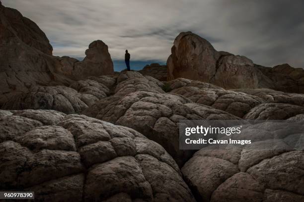 silhouette hiker standing on marble canyon against cloudy sky - vermilion cliffs imagens e fotografias de stock