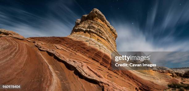 low angle view of rock formations against cloudy sky at marble canyon - marble canyon foto e immagini stock