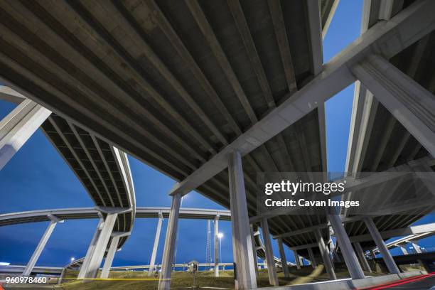 low angle view of elevated road against sky at night - amarillo color stock-fotos und bilder