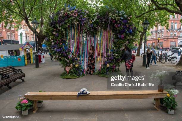 Woman walks through a heart shaped floral display in the centre of Sloane Square during the Chelsea in Bloom floral art show on May 21, 2018 in...