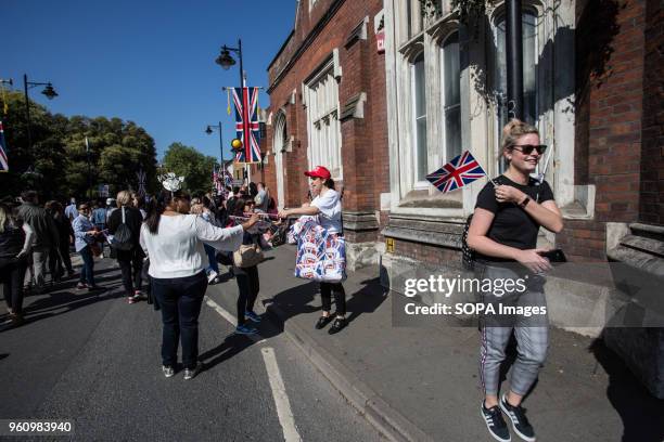 People seen with the Union Jack flag. The wedding of Prince Harry and Meghan Markle was held on 19 May 2018 in St George's Chapel at Windsor...