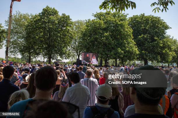 People seen watching the wedding on a large screen in Windsor. The wedding of Prince Harry and Meghan Markle was held on 19 May 2018 in St George's...