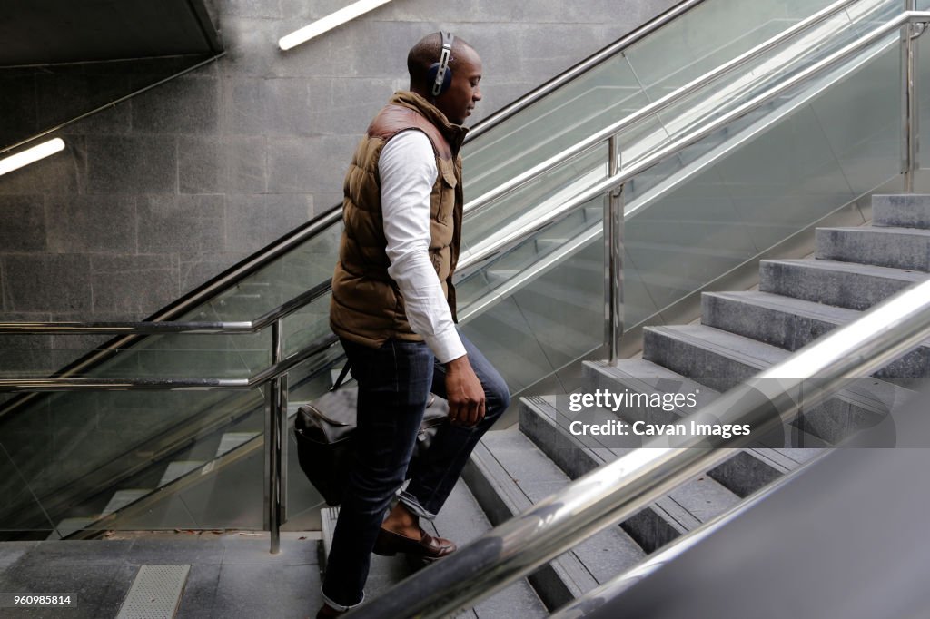 Side view of man climbing steps at subway station