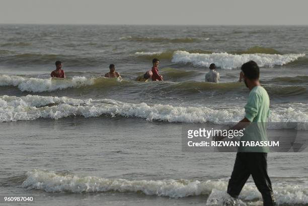 Pakistani residents cool off at Clifton beach during a heat wave in Karachi on May 21, 2018. - Residents of Pakistan's largest city Karachi were...