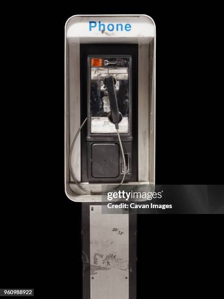 pay phone on black background - pay phone stock pictures, royalty-free photos & images