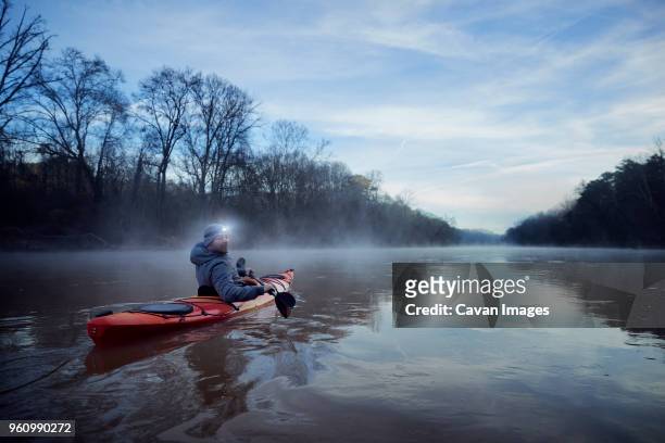 portrait of man kayaking on chattahoochee river against sky - boat side view stock pictures, royalty-free photos & images