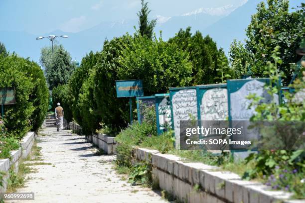 An elderly man walks inside the martyr's graveyard during restrictions imposed ahead of a march to the martyrs graveyard called by the separatist...