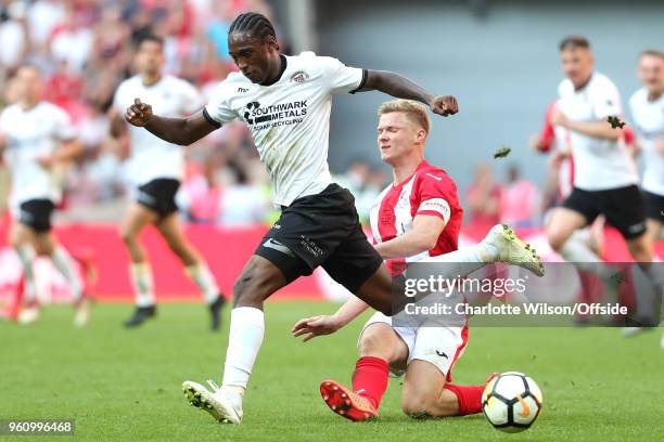 Gareth Dean of Brackley sends the ball through the legs of Brandon Hanlan of Bromley during The Buildbase FA Vase Final between Stockton Town and...