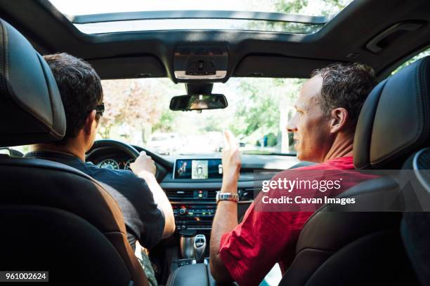 rear view of homosexual couple travelling in car - two cars ストックフォトと画像