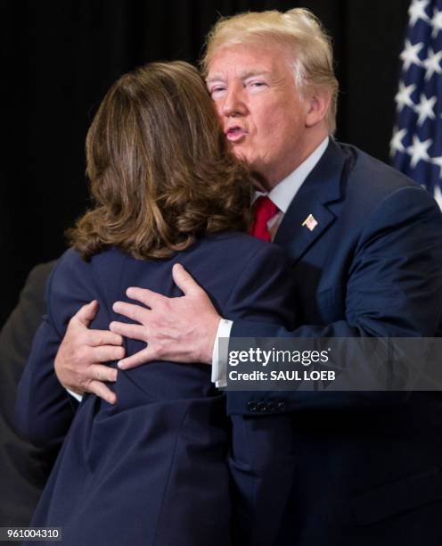 President Donald Trump embraces Gina Haspel after she was sworn-in as Director of the Central Intelligence Agency at CIA Headquarters in Langley,...