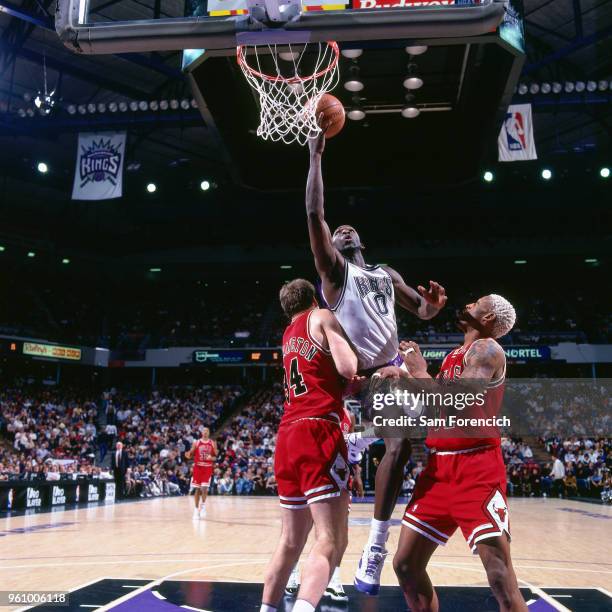 Olden Polynice of the Sacramento Kings goes to the basket against the Chicago Bulls on February 1, 1996 at ARCO Arena in Sacramento, California. NOTE...