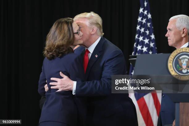 President Donald Trump and Gina Haspel embrace as Vice President Mike Pence looks on during the swearing-in ceremony for Haspel as CIA director at...