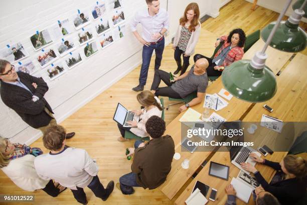 high angle view of business people discussing in meeting at board room - brainstorming wall stock pictures, royalty-free photos & images