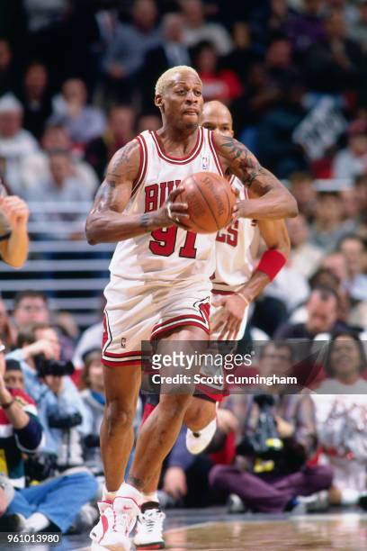 Dennis Rodman of the Chicago Bulls passes the ball against the Houston Rockets on January 3, 1996 at the United Center in Chicago, Illinois. NOTE TO...