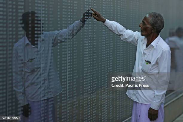 An old man looking the names of the fallen soldiers who died in the decades-long conflict against the Tamil Tigers, during a commemorative ceremony...