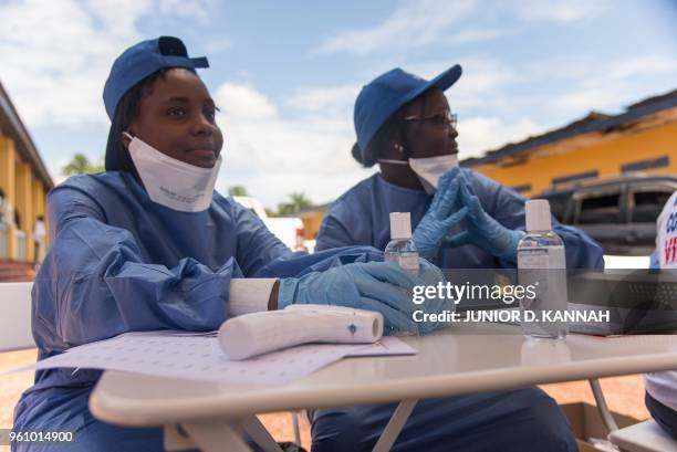 Nurses working with the World Health Organization prepare to administer vaccines at the town all of Mbandaka on May 21, 2018 during the launch of the...