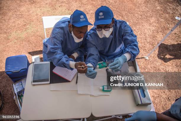 Nurses working with the World Health Organization prepare to administer vaccines at the town all of Mbandaka on May 21, 2018 during the launch of the...